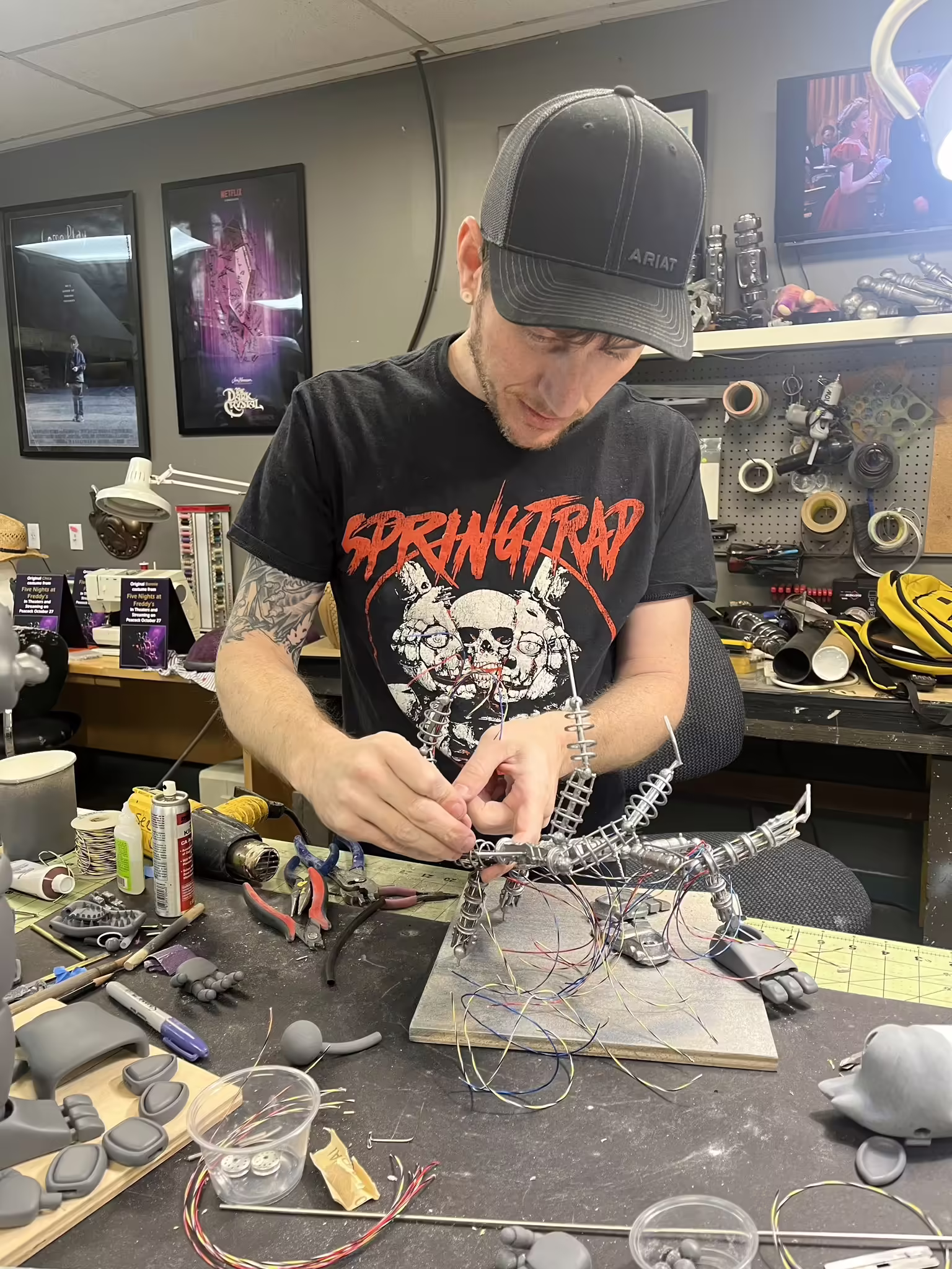 Robert Bennet working on model prototype versions of The Mangle and Toy Bonnie animatronics. Plaques and props from the first movie visible in the background.