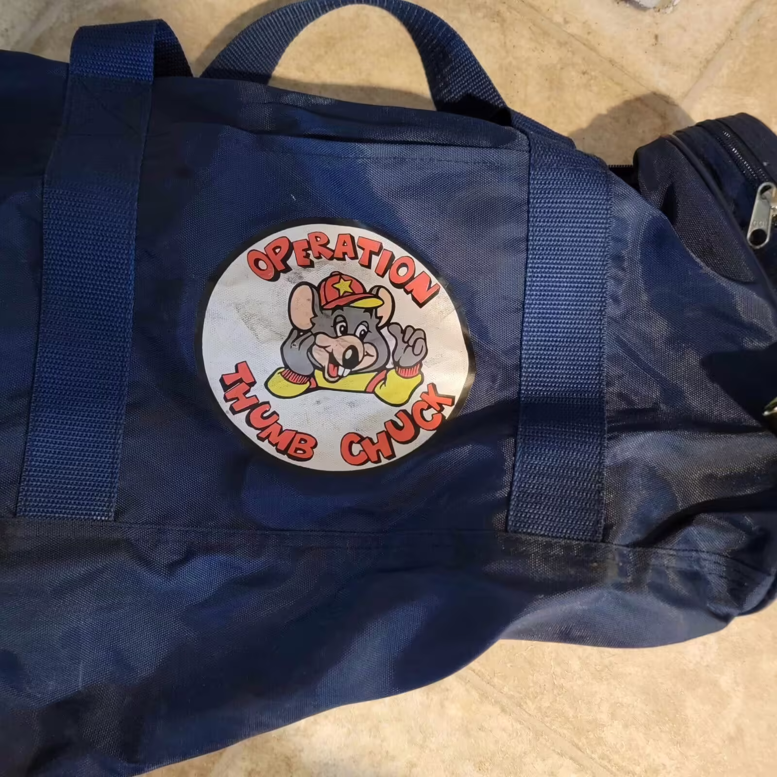 Listed on an eBay as 'Chuck E. Cheese's ULTRA RARE Operation Thumb Chuck Duffle bag' with the claim that it was handed out during a manager's convention. https://web.archive.org/web/20240601010350/https://www.ebay.com/itm/305428923373